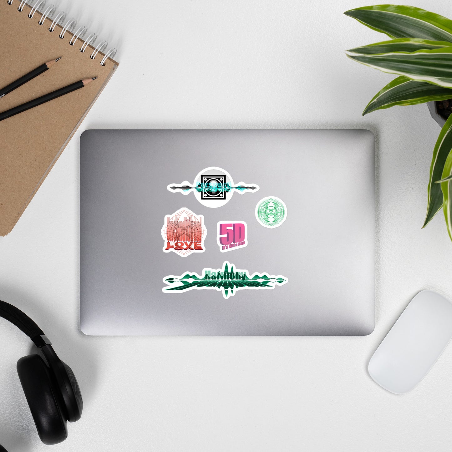 Unconditional Love, Harmony, 5D, and Geometric Design Stickers on a laptop screen - durable high-quality vinyl stickers for personalizing your devices
