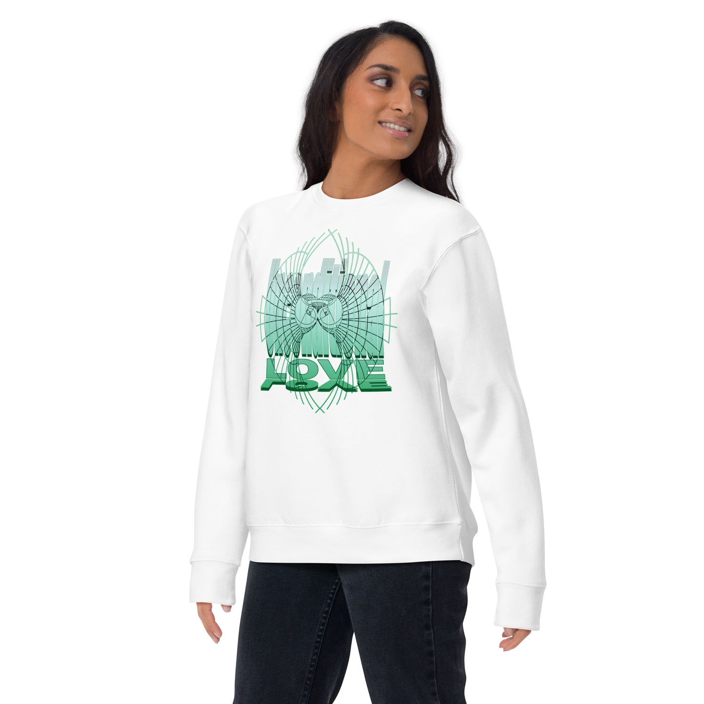 Female model wearing a white unisex sweatshirt with green 'Unconditional Love' design featuring the words and a heart with wings in a torus shape, symbolizing mindfulness and compassion.